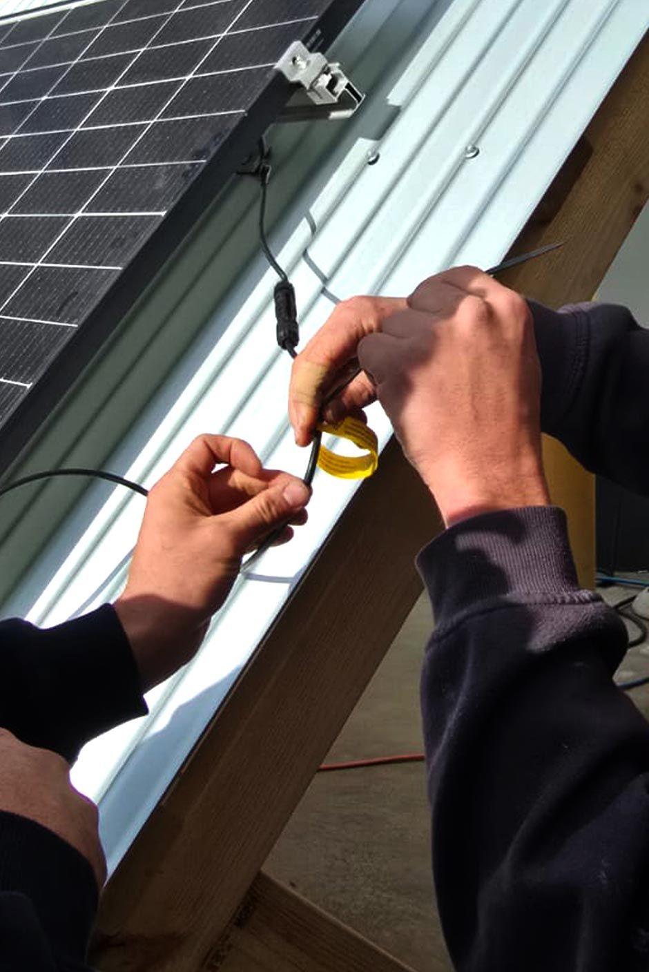 students performing electrical safety testing on solar equipment during a Test and Tag training session.