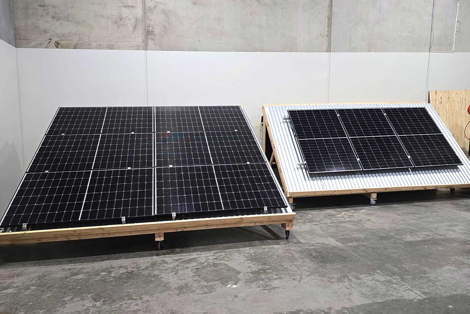 Two solar panel training rigs set up in the workshop for hands-on
